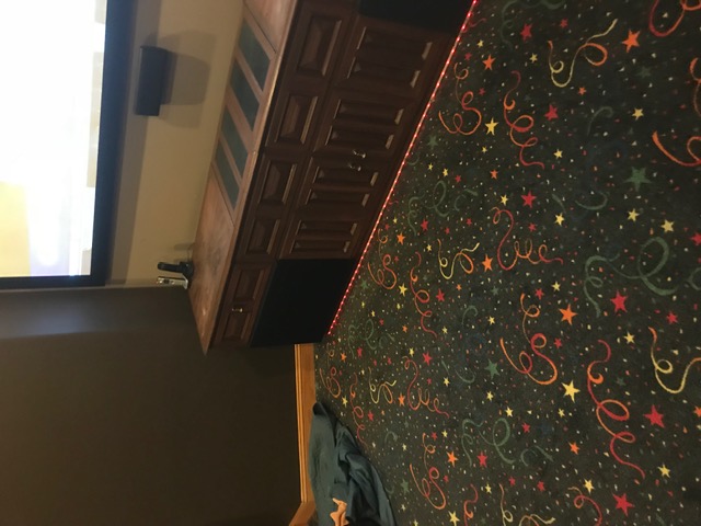 Red LED accent lighting glowing along the base of a theater console