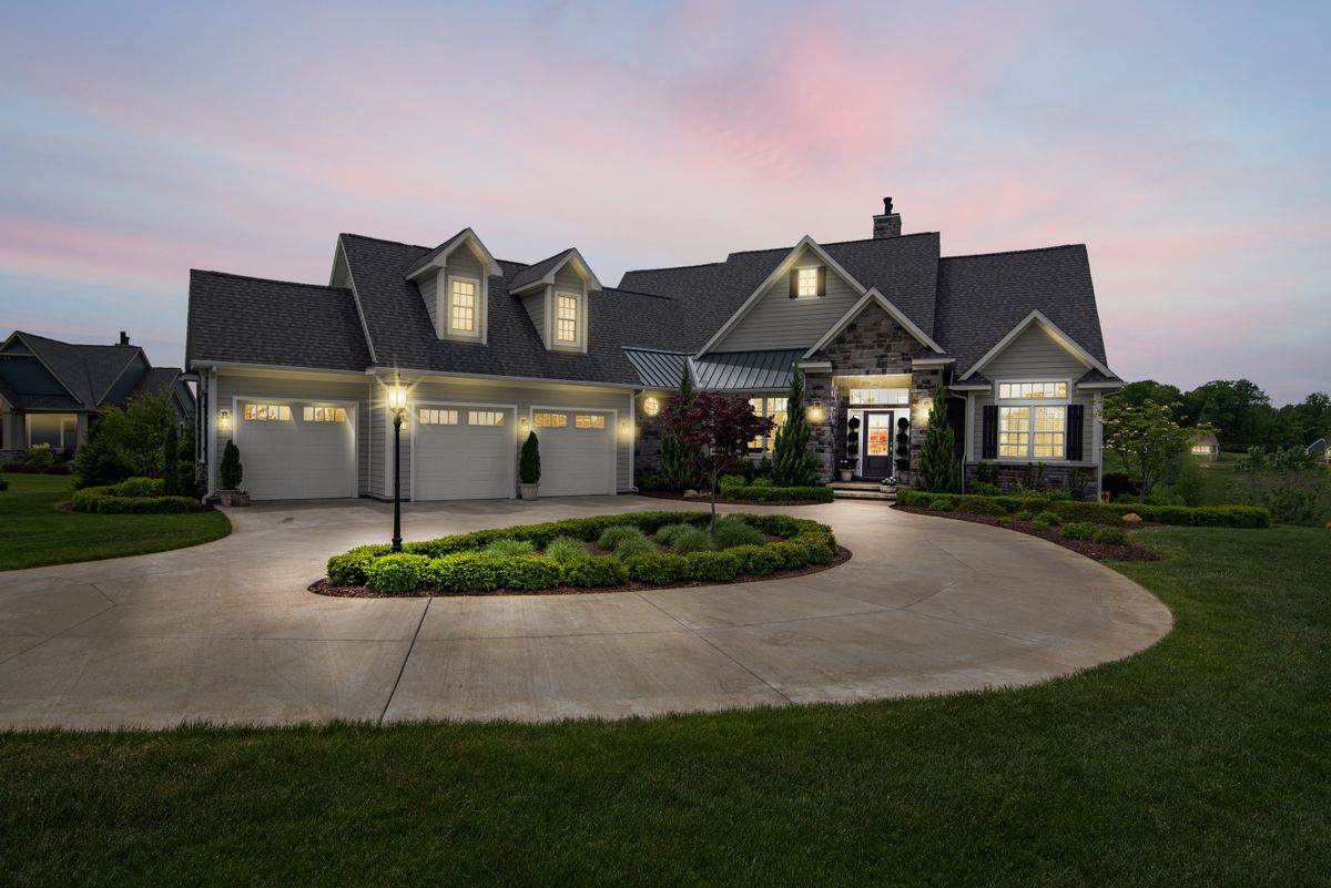 Home with warm exterior lighting at dusk (stock image — to be replaced with a real project photo)