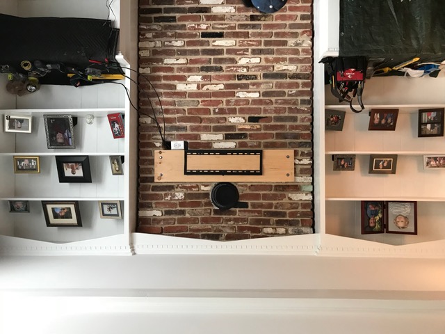 TV recessed into a brick chimney between white built-ins in Barnegat NJ