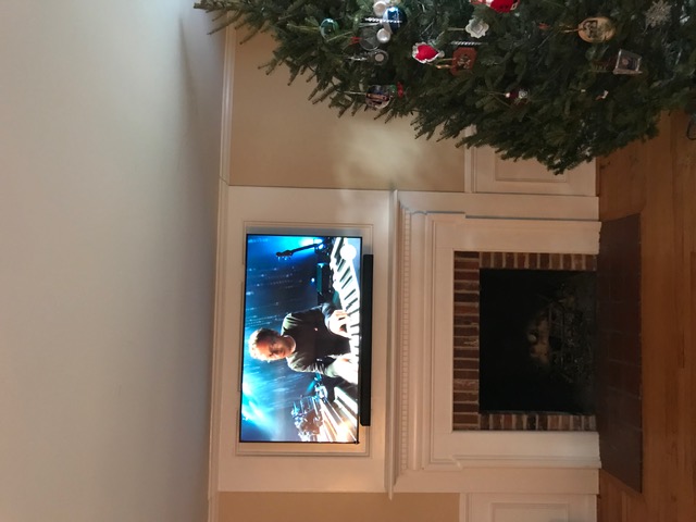 TV and soundbar mounted above brick fireplace in NJ living room
