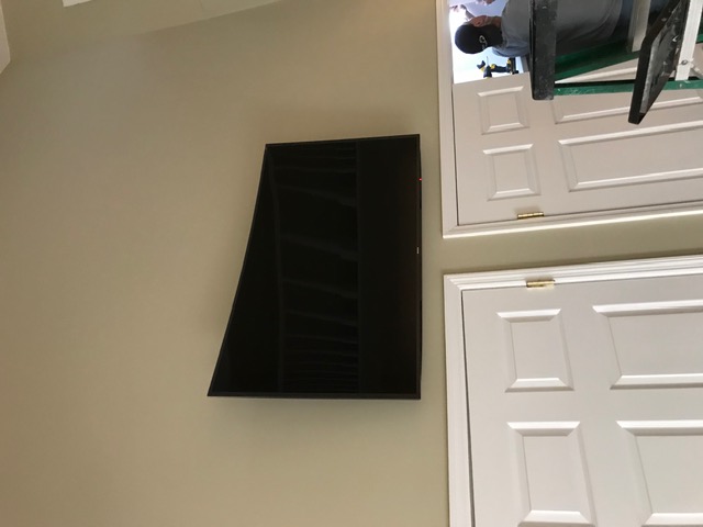 Curved Samsung TV wall mounted in bedroom in NJ