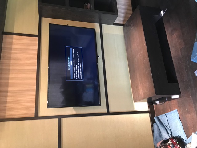 TV mounted in modern entertainment wall unit with wood panels in NJ