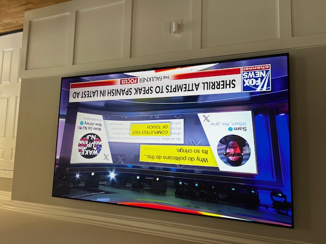 Large TV wall mounted in living room with wainscoting in South Jersey