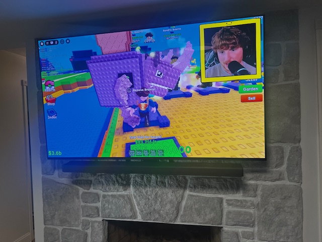 TV mounted above stone fireplace in NJ living room